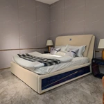 Light Beige Upholstered Bed with Brand Emblem, Navy Accent Stripe & Gold Stainless Steel Feet